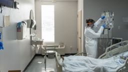 A nurse wearing protective gear treats a patient in the Covid-19 intensive care unit (ICU) at the United Memorial Medical Center (UMMC) in Houston, Texas, U.S., on Monday, June 29, 2020. Covid-19 cases and hospitalizations have spiked since Texas reopened eight weeks ago, pushing intensive-care wards to full capacity and sparking concerns about a surge in fatalities as the contagion spreads. Photographer: Go Nakamura/Bloomberg via Getty Images